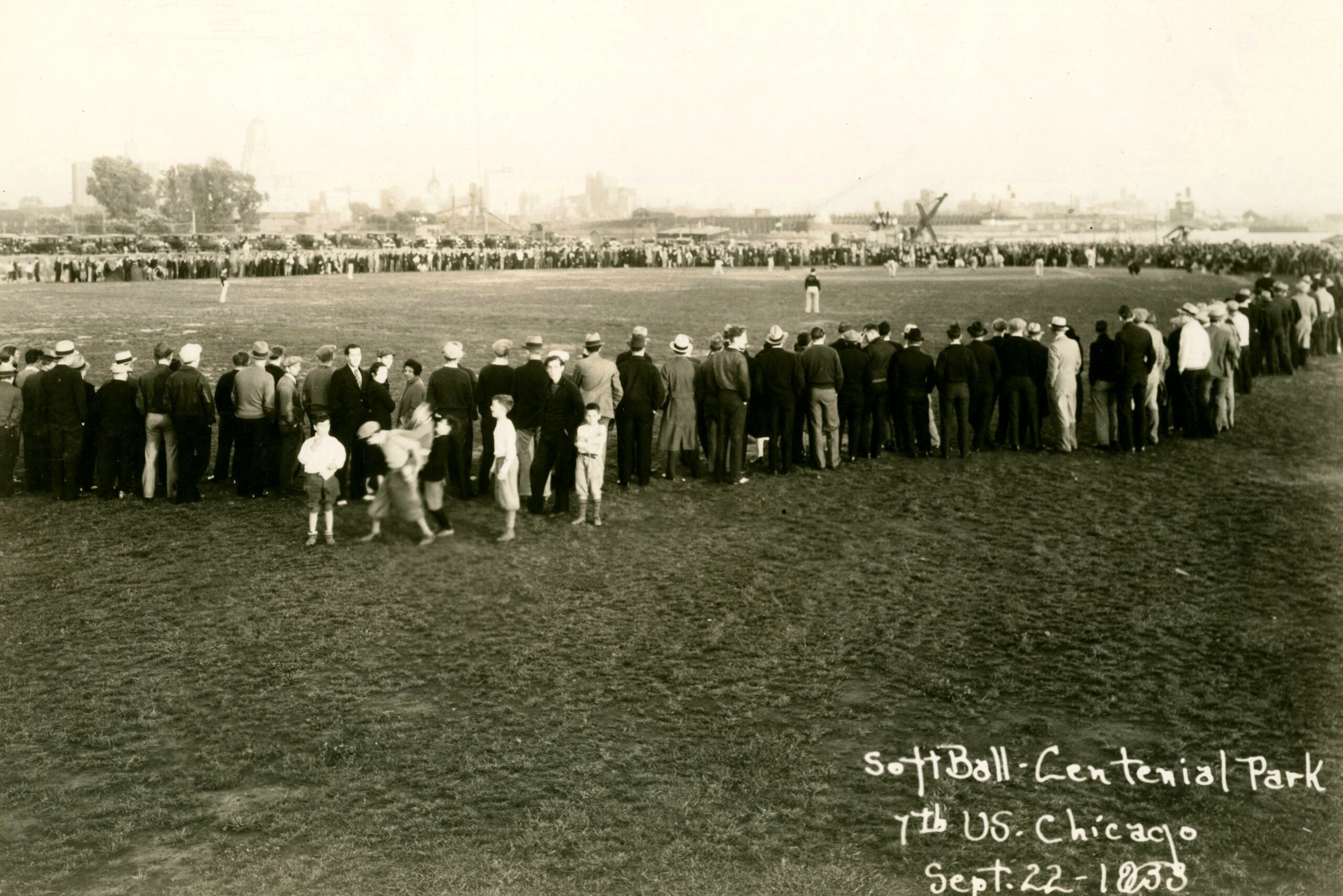 Community gathering for a softball game at the park in 1933