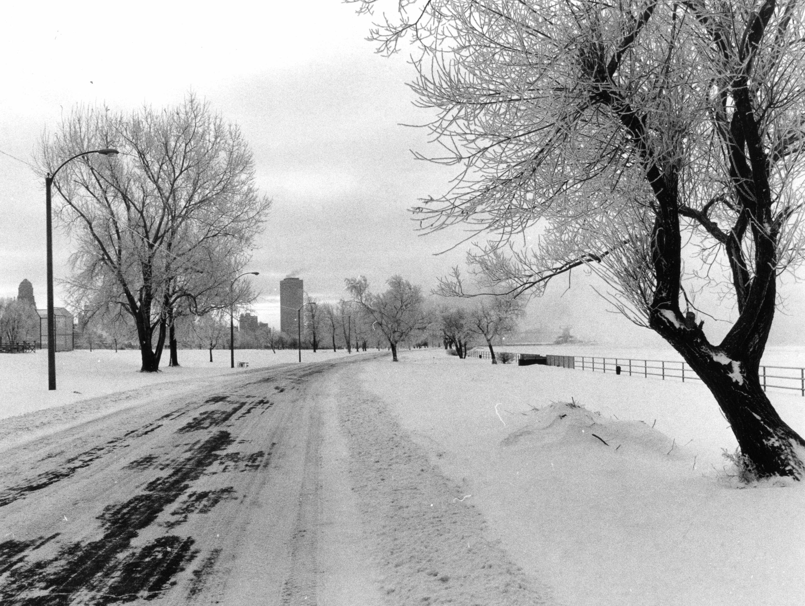 Icy road in LaSalle Park with city skyline in distance, January 19, 1979. Collection of the Buffalo History Museum.